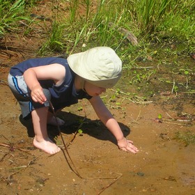 baby playing in a stream